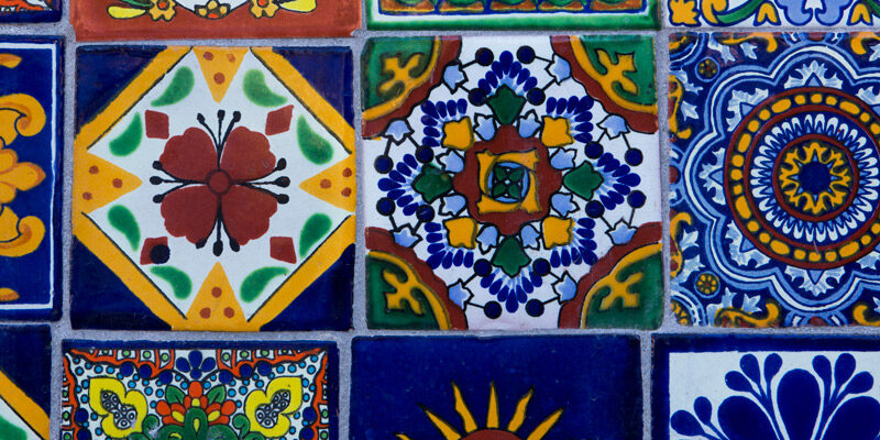 hand painted tile with blues, reds, and yellows