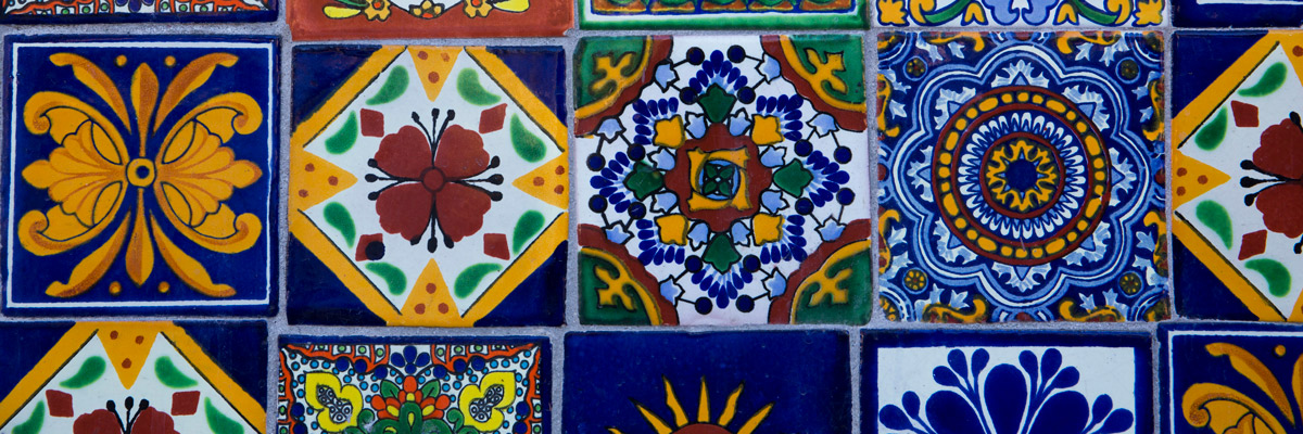 hand painted tile with blues, reds, and yellows